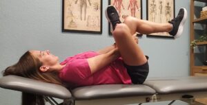 A patient performs figure 4 piriformis stretch for hip pain